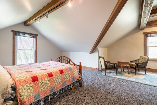 carpeted bedroom with vaulted ceiling with beams, rail lighting, and baseboards