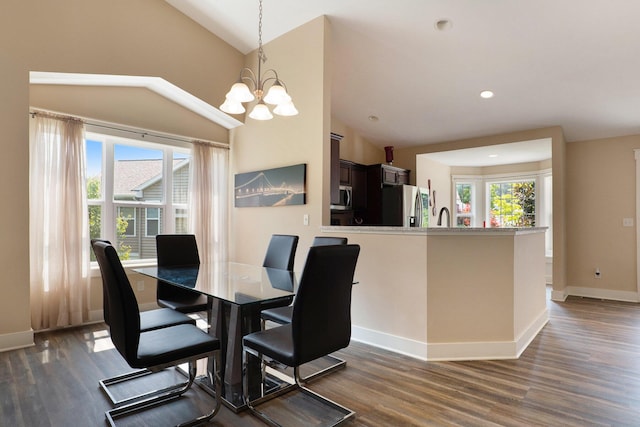 dining room featuring dark wood finished floors, recessed lighting, baseboards, a notable chandelier, and lofted ceiling