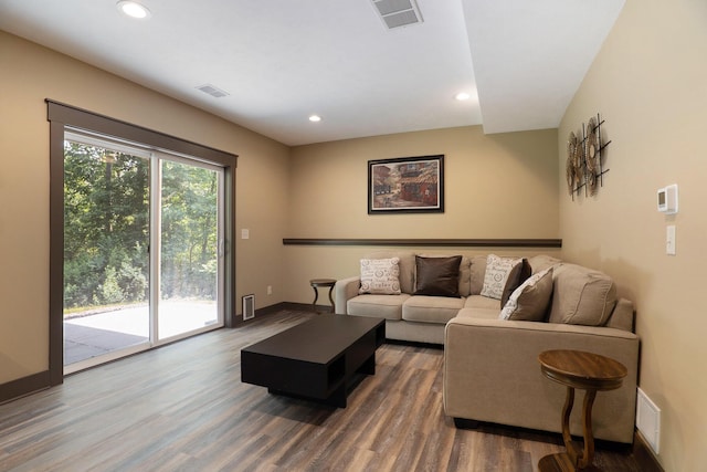 living room featuring recessed lighting, visible vents, and wood finished floors