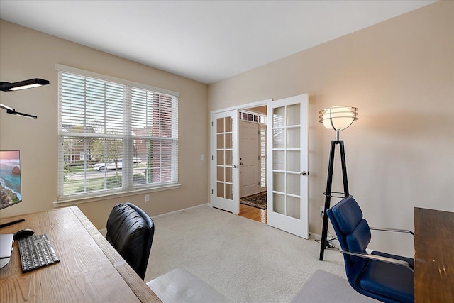 office area featuring baseboards, french doors, and carpet