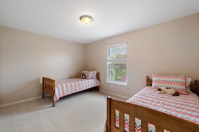 carpeted bedroom with baseboards