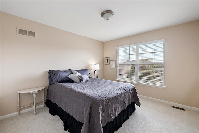 bedroom featuring light colored carpet, baseboards, and visible vents