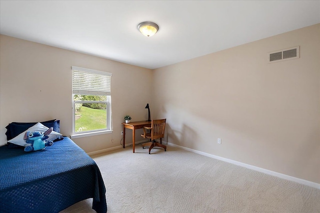bedroom with carpet floors, baseboards, and visible vents