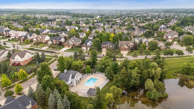 birds eye view of property with a water view and a residential view