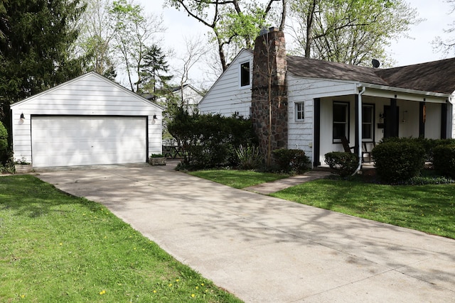view of property exterior with an outbuilding, a chimney, a lawn, and a detached garage