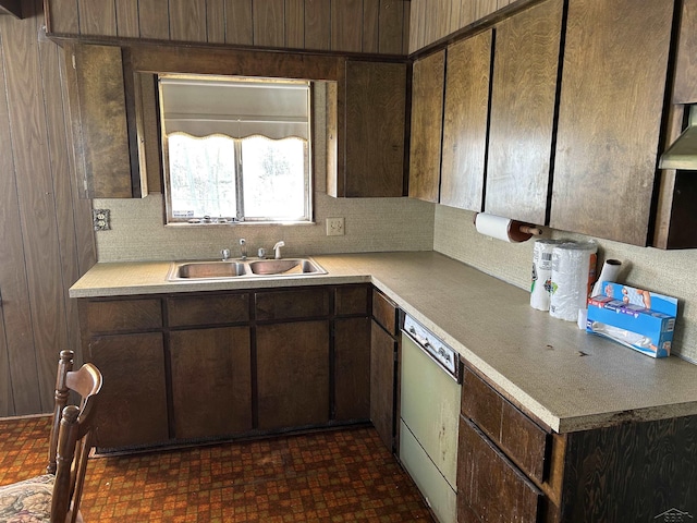 kitchen with a sink, dishwasher, dark brown cabinets, and light countertops