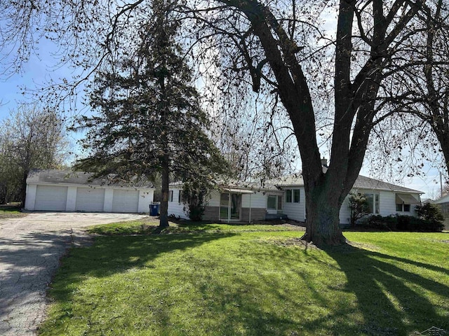 single story home with driveway and a front yard