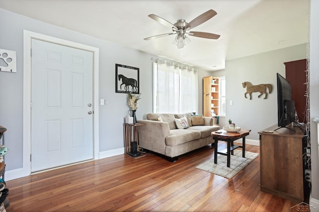 living room with hardwood / wood-style floors, baseboards, and a ceiling fan