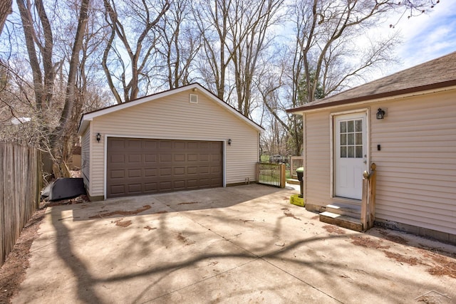 detached garage featuring fence