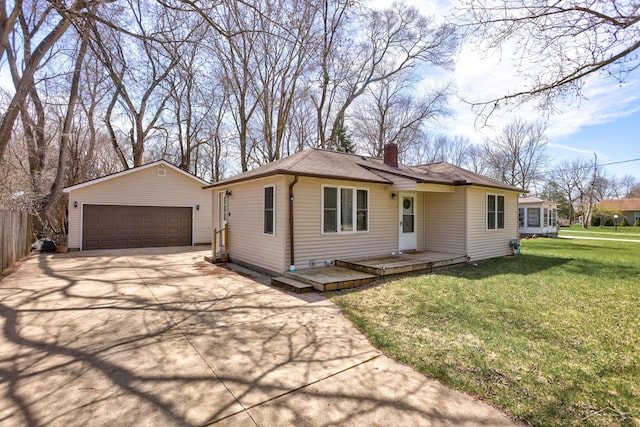 view of front of house featuring an outbuilding, a detached garage, a front lawn, and a chimney