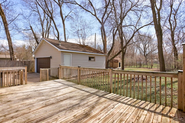 wooden deck with a garage and an outbuilding