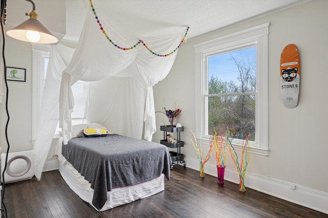 bedroom featuring dark wood-type flooring and baseboards