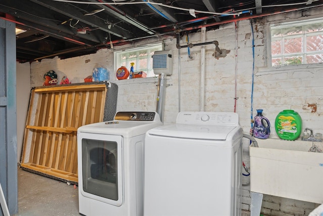 laundry area featuring a sink, laundry area, and washer and clothes dryer