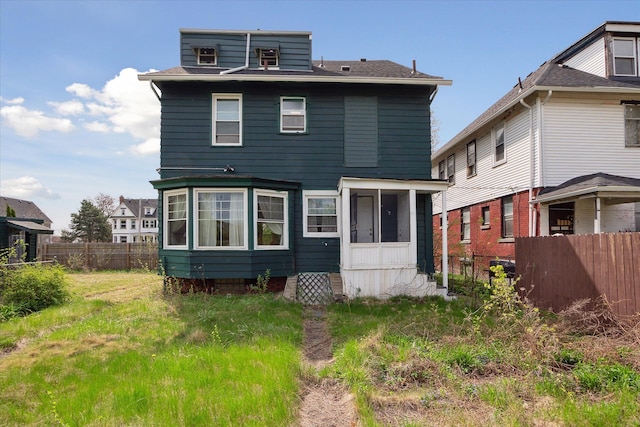 back of house featuring fence