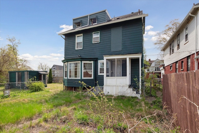 back of property featuring fence