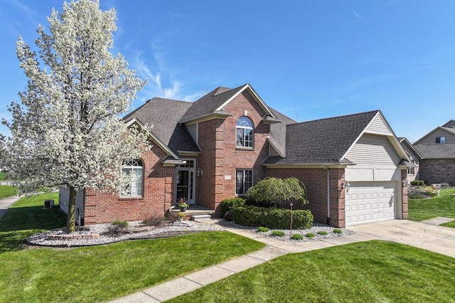 1355 Ridge View Ct, Grand Blanc, MI 48439 - traditional-style house featuring brick siding, an attached garage, driveway, and a front yard
