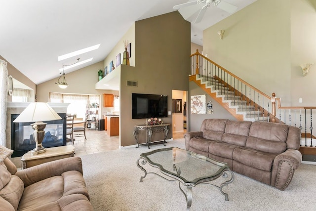1355 Ridge View Ct, Grand Blanc, MI 48439 - living room featuring high vaulted ceiling, a multi sided fireplace, a ceiling fan, a skylight, and stairway