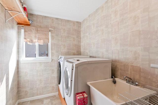 1355 Ridge View Ct, Grand Blanc, MI 48439 - clothes washing area featuring laundry area, tile walls, washing machine and dryer, a sink, and baseboards