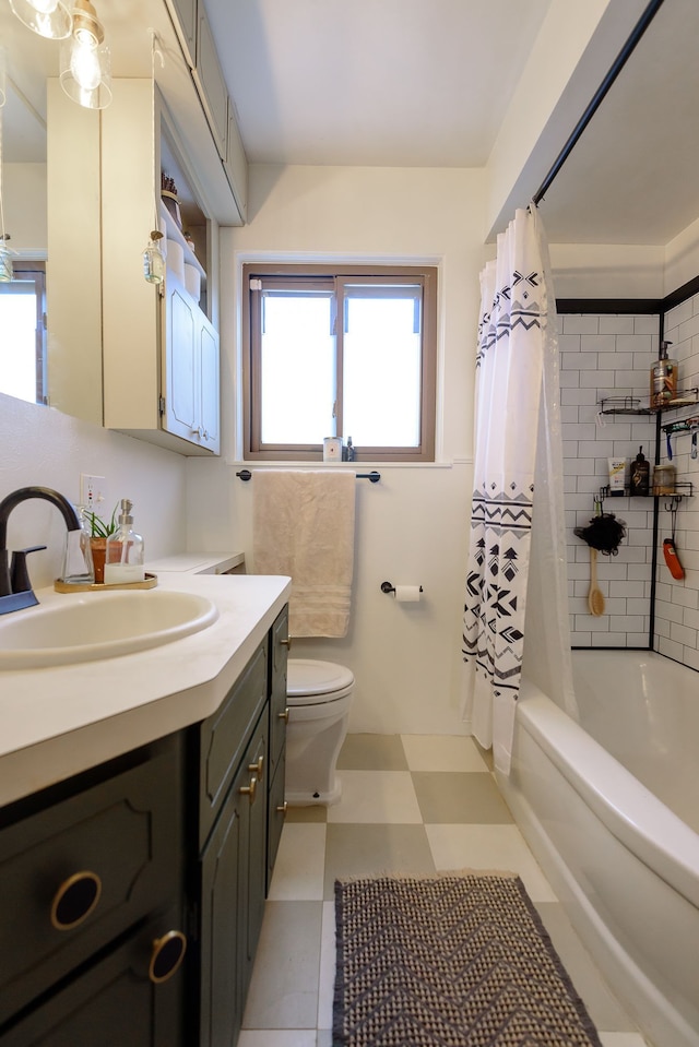 bathroom featuring toilet, tile patterned floors, shower / bath combo, and vanity