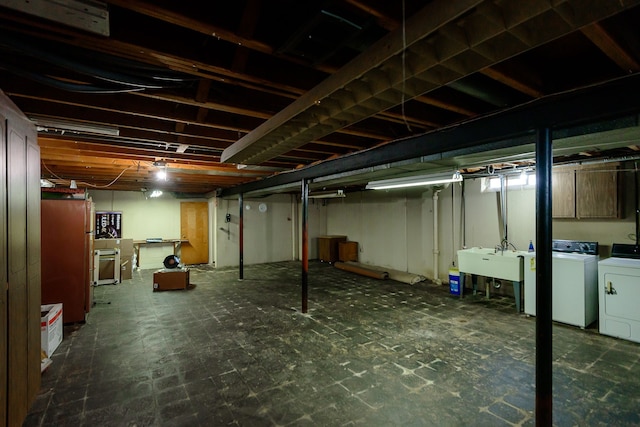 unfinished basement with washer and dryer and a sink
