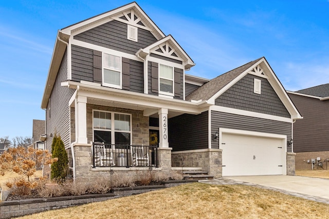 2670 Ironton Dr, Commerce Twp, MI 48382 - craftsman-style house featuring a front lawn, covered porch, driveway, stone siding, and an attached garage