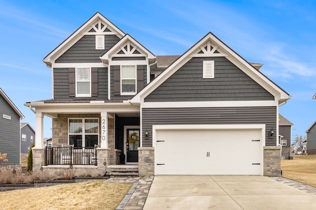 2670 Ironton Dr, Commerce Twp, MI 48382 - craftsman-style home featuring concrete driveway, stone siding, a front lawn, and covered porch