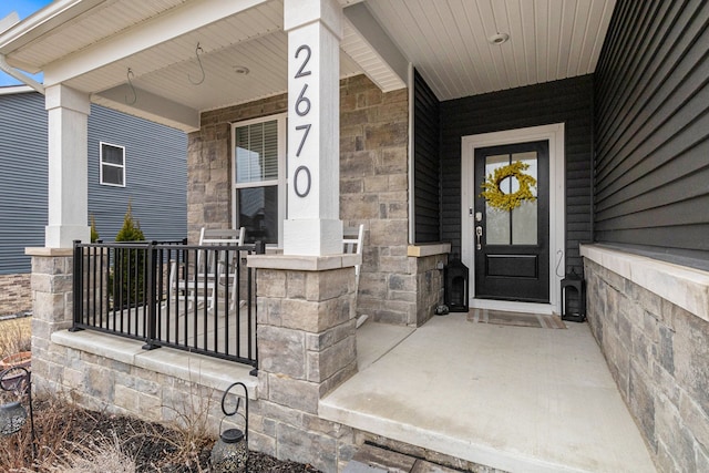 2670 Ironton Dr, Commerce Twp, MI 48382 - doorway to property featuring a porch and stone siding