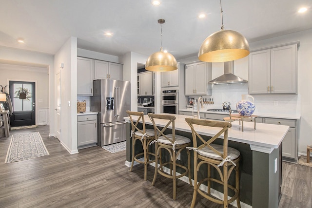 2670 Ironton Dr, Commerce Twp, MI 48382 - kitchen with wall chimney exhaust hood, gray cabinetry, appliances with stainless steel finishes, and light countertops