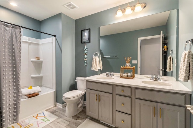 2670 Ironton Dr, Commerce Twp, MI 48382 - bathroom featuring wood finished floors, double vanity, toilet, a sink, and visible vents