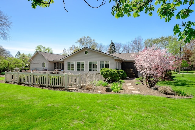 back of property featuring a lawn