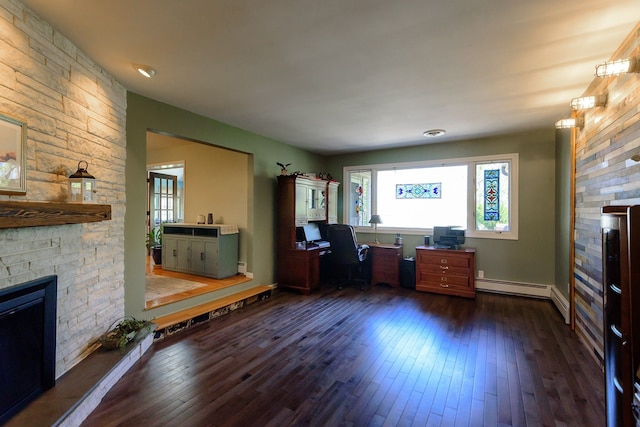 office area with dark wood-style flooring, baseboards, a wealth of natural light, and a fireplace