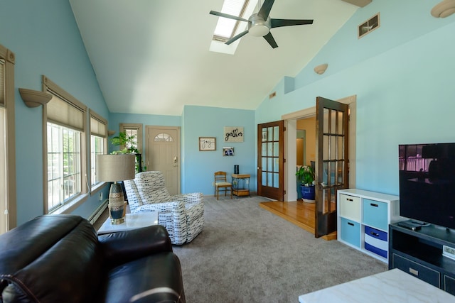 carpeted living area featuring high vaulted ceiling, french doors, a ceiling fan, a skylight, and visible vents