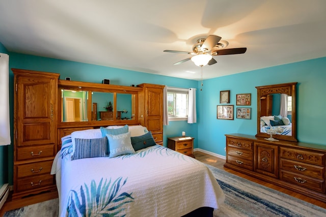bedroom with baseboards, a ceiling fan, and wood finished floors