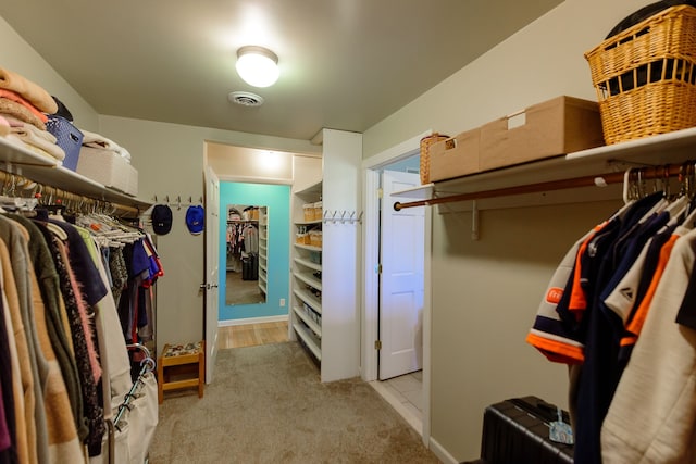 spacious closet with visible vents and carpet floors