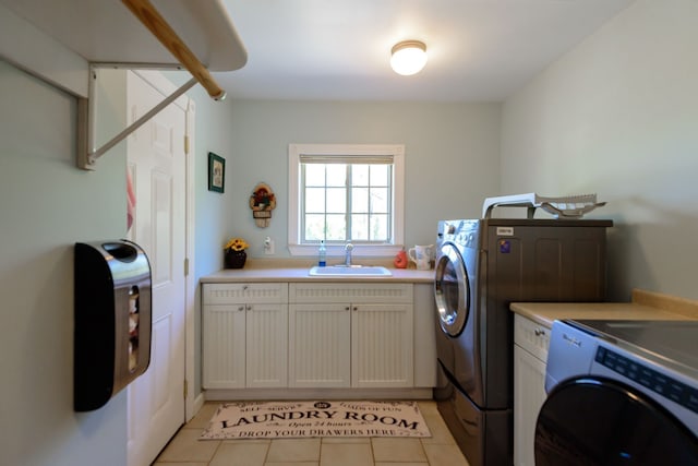 laundry area with separate washer and dryer, a sink, cabinet space, and light tile patterned floors