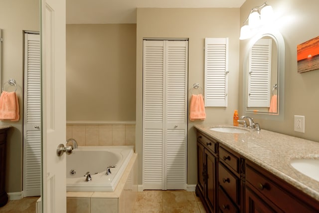 full bath with a closet, a sink, a whirlpool tub, and double vanity