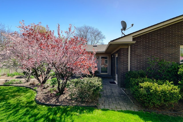 view of exterior entry with brick siding