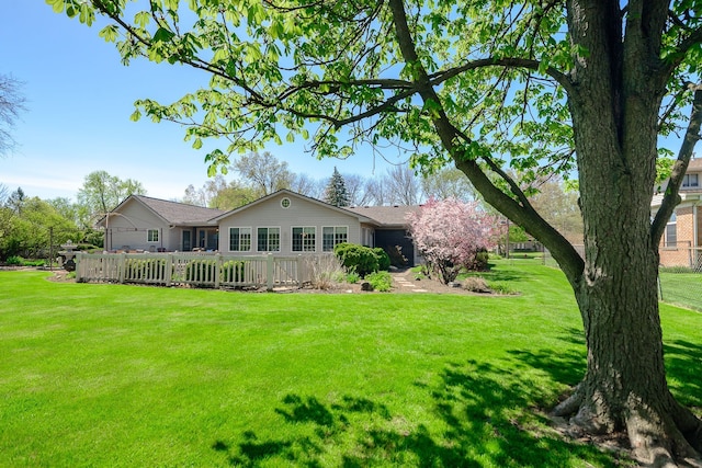 back of house featuring a lawn