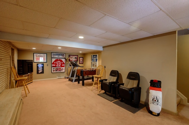 exercise room featuring carpet floors, baseboards, and a drop ceiling