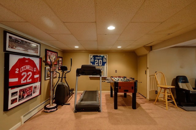 exercise room with carpet floors, baseboards, a drop ceiling, recessed lighting, and a baseboard heating unit