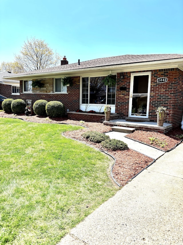 3440 Maidstone St, Trenton, MI 48183 - single story home featuring brick siding, a chimney, and a front yard