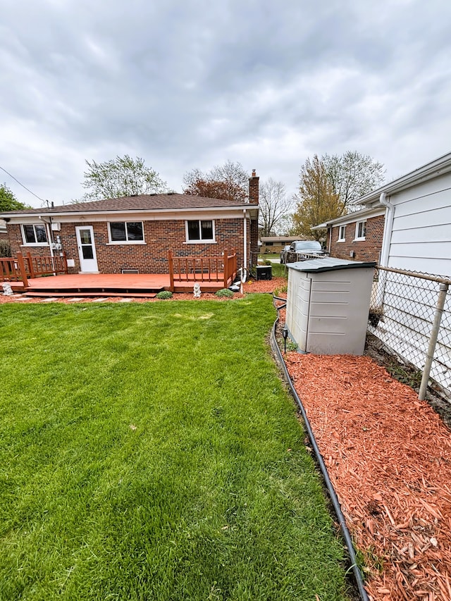 3440 Maidstone St, Trenton, MI 48183 - back of house featuring brick siding, fence, a chimney, and a deck