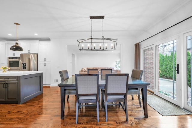dining space featuring recessed lighting, a notable chandelier, crown molding, visible vents, and dark wood finished floors