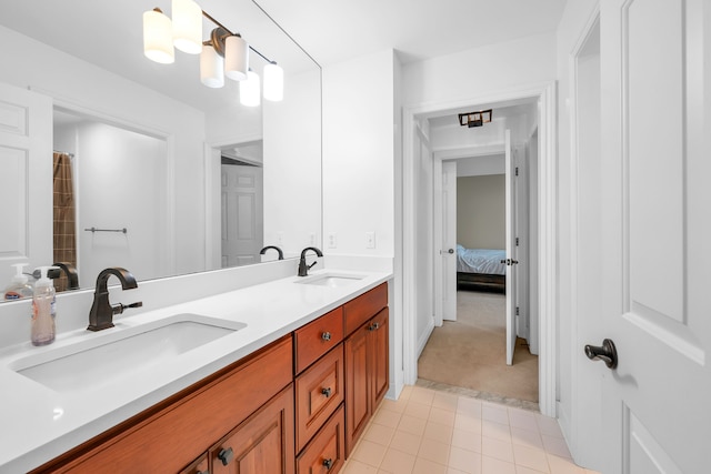 full bath featuring double vanity, a sink, and tile patterned floors
