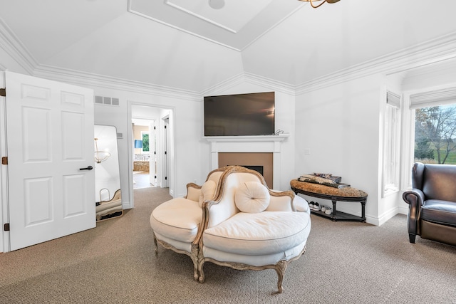 living area featuring carpet floors, vaulted ceiling, ornamental molding, a fireplace, and visible vents