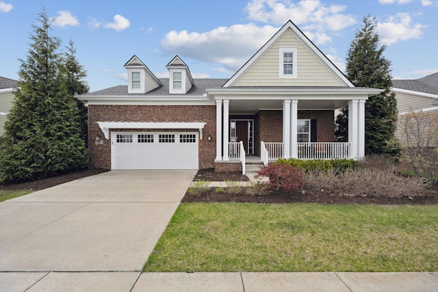 view of front of house with an attached garage, a porch, a front lawn, and brick siding