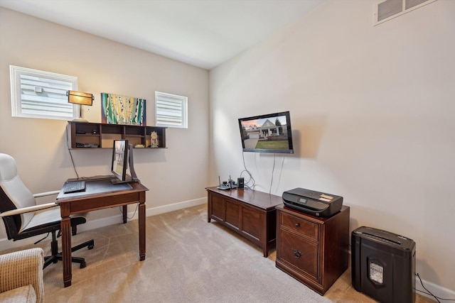 office featuring visible vents, baseboards, and light carpet