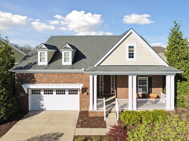 view of front facade featuring a shingled roof, brick siding, a garage, a porch, and driveway