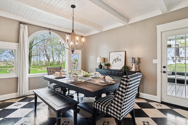 dining room featuring baseboards, beam ceiling, and a notable chandelier