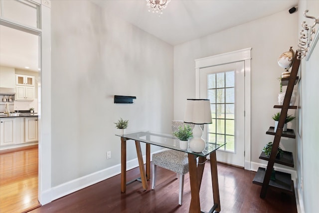 office area featuring baseboards and wood finished floors